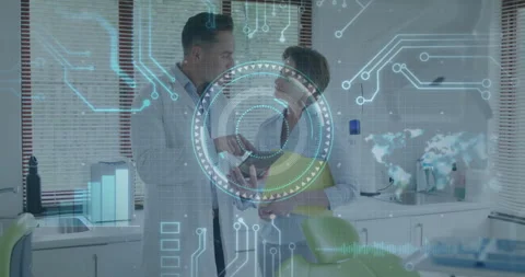 Dentist tapping tablet to open 3D scan while holographic interface appears for Video stock 314790663