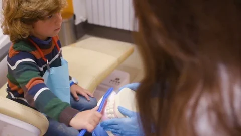 The dentist tells the child about oral hygiene Stock Footage 84785853