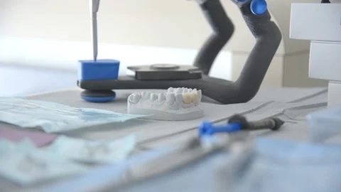 Dentist tools and dentures on table in clinic Stock Footage 89976427