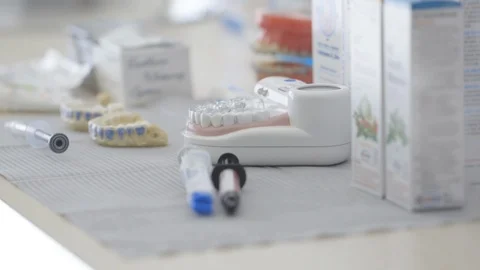 Dentist tools and dentures on table in clinic Stock Footage 89976489