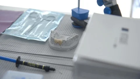 Dentist tools and dentures on table in clinic Stock Footage 90014176