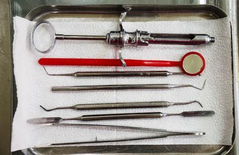 Dentist tools in an iron box on the table, close up. Stock Photos