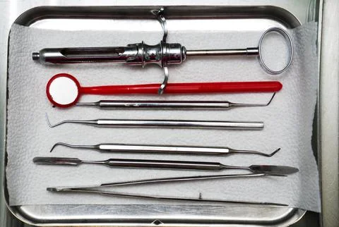 Dentist tools in an iron box on the table, close up. Stock Photos