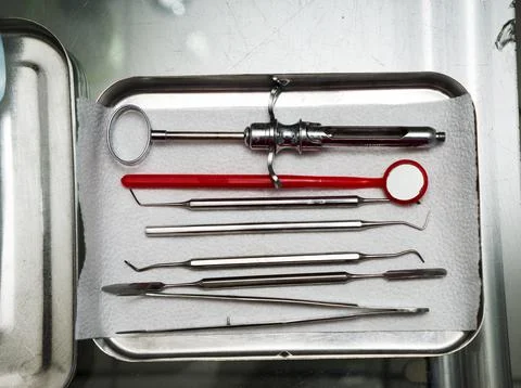 Dentist tools in an iron box on the table, close up. Stock Photos