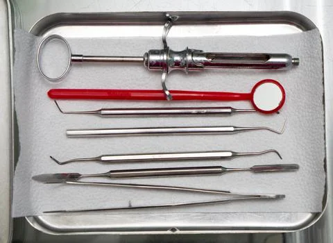 Dentist tools in an iron box on the table, close up. Stock Photos
