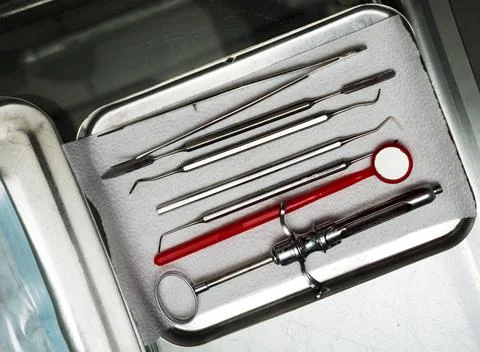 Dentist tools in an iron box on the table, close up. Stock Photos
