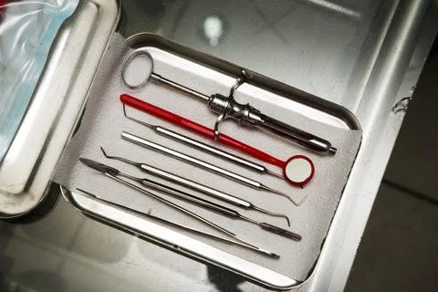 Dentist tools in an iron box on the table, close up. Stock Photos