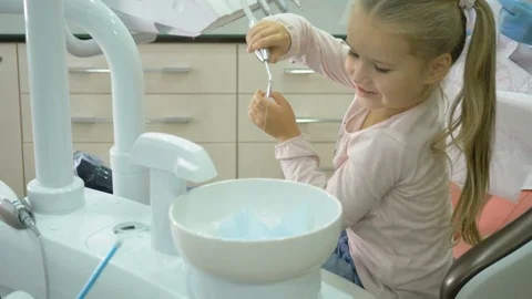 A dentist is treating the teeth to the child. Stock Footage 83135985