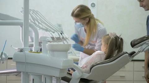 A dentist is treating the teeth to the child. Stock Footage 83136088