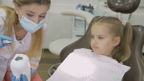 A dentist is treating the teeth to the child. Stock Footage 83136248