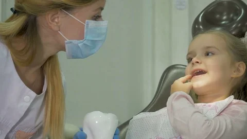 A dentist is treating the teeth to the child. Stock Footage 83136323