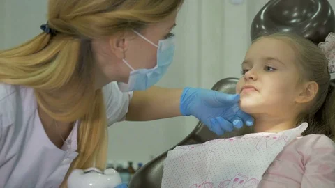 A dentist is treating the teeth to the child. Stock Footage 83136395