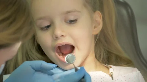 A dentist is treating the teeth to the child. Stock Footage 83136421