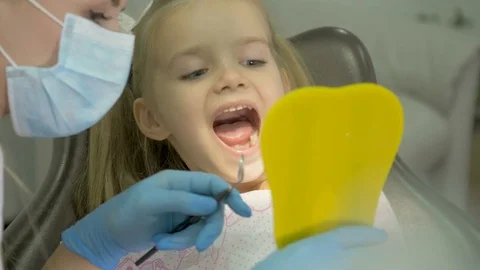 A dentist is treating the teeth to the child. Stock Footage 83136513
