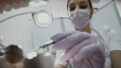 Dentist uses angular probe and mirror to check the teeth in mouth of patient Stock Footage 81818316