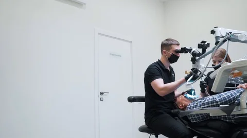 Dentist uses technological equipment to diagnose Stock Footage 112134428