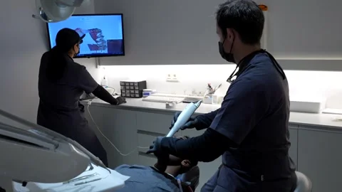 Dentist using 3d scanner on patient's teeth in modern clinic Stock Footage 306061160