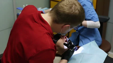 Dentist using a dental microscope Stock Footage 62870518