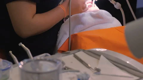 A dentist using forceps to remove cotton during a proceedure Stock Footage 63210254