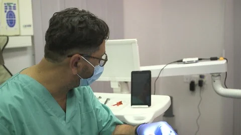Dentist using tablet for treatment medium shot Stock Footage 113191663