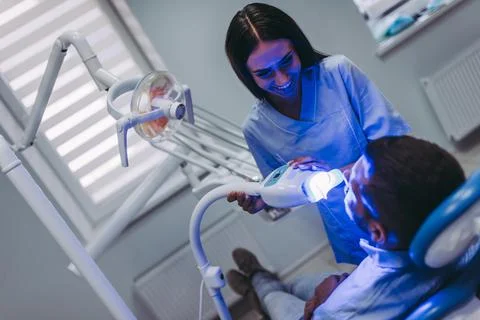 Dentist using uv lamp Stock Photos