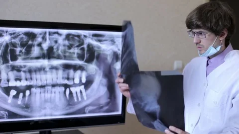 Dentist watching x-rays Stock Footage 79669312