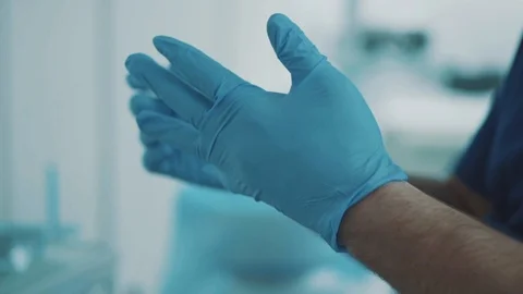 Dentist wears gloves before starting work Stock Footage 93523441