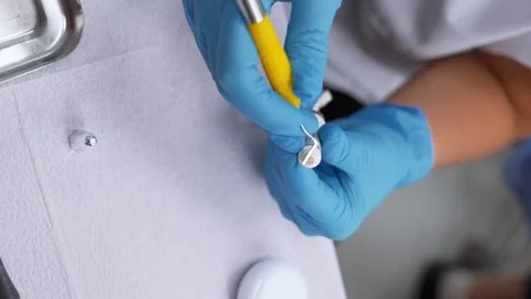 Dentist will take material out of tooth filling tube with instrument Stock Footage 258689160