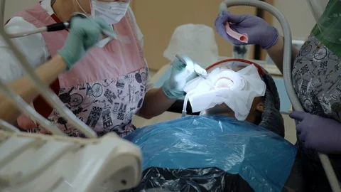 A Dentist at work with patient Stock Footage 119046086