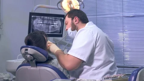 Dentist at work with the patient in the office of a private clinic Stock Footage 72800907