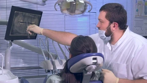 Dentist at work shows an X-ray snapshot of a patient Stock Footage 72797947