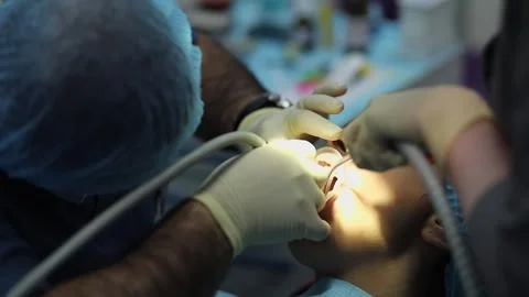 Dentist work with washer and assistant uses saliva sucker in patients mouth. Stock-Footage 276366982