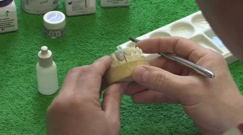 Dentist working with ceramic material, brush and dentures. Workplace dental Stock Footage 65215142