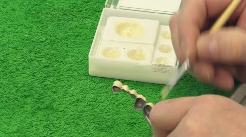 Dentist working with ceramic material, brush and dentures. Workplace dental Stock Footage 65215425