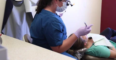 Dentist Working on Patients Teeth Dolly Right Stock Footage 57754932