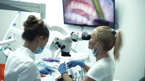 Dentist workwith assistant with oral camera and monitor, looking at ocular Stock Footage 70040098