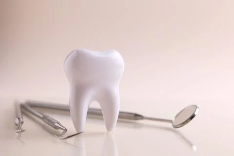 Dentistry concept. Model of a tooth and dental instruments on a colored Foto stock