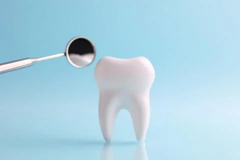 Dentistry concept. Model of a tooth and dental instruments on a colored Foto stock