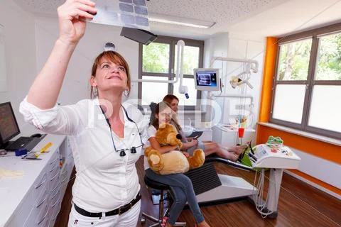 A dentistry doctor looks a x-ray picture in a doctor-surgery Stock Photos