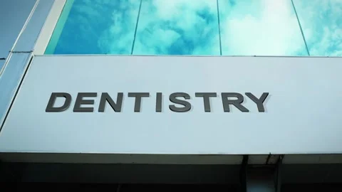 Dentistry Sign on Modern Building with Cloud Reflection on Windows Glass Stock Footage 303556370