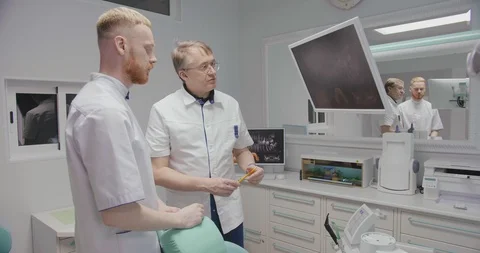 Dentists discussing x-ray Stock Footage 109563916