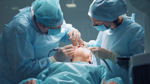 Dentists during surgery for implant placement. Dental clinic concept. Stock Footage 110699417