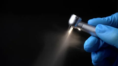 Dentist's hand with drill illustrates work of dental drill Stock Footage 237700376