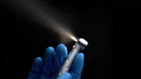 Dentist's hand with drill illustrates work of dental drill Stock Footage 237700478