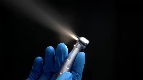 Dentist's hand with drill illustrates work of dental drill Stock Footage 237700514