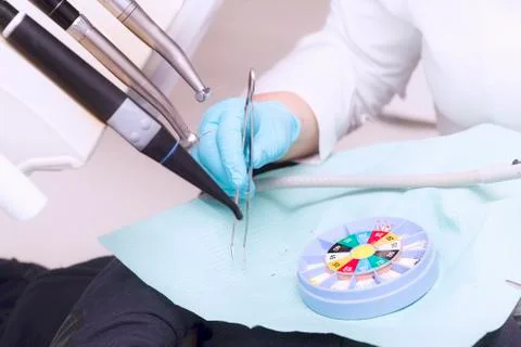 Dentist's hand with glove and dentist's tools Stock Photos