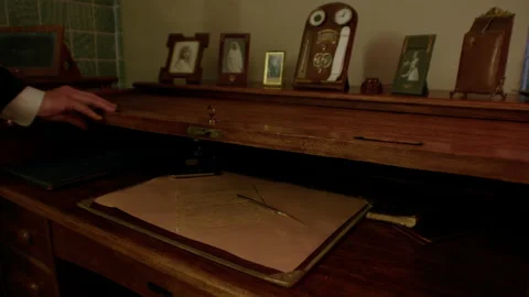 The dentist's hand opens a vintage desk with writing utensils. Stock Footage 221842603