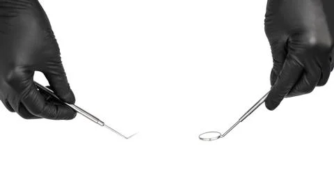 Dentist's hands with tools isolated on white. Stock Photos