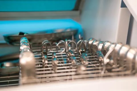 Dentist's instruments in the sterilizer. Various iron tools used in dentistry to Foto stock