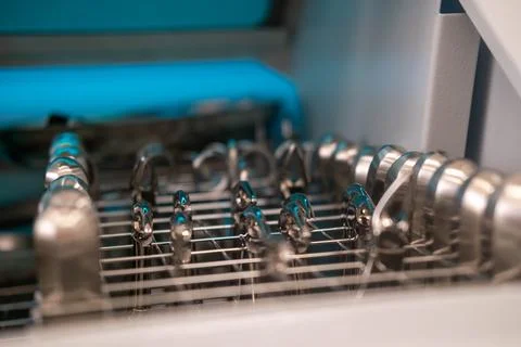 Dentist's instruments in the sterilizer. Various iron tools used in dentistry to Stock Photos